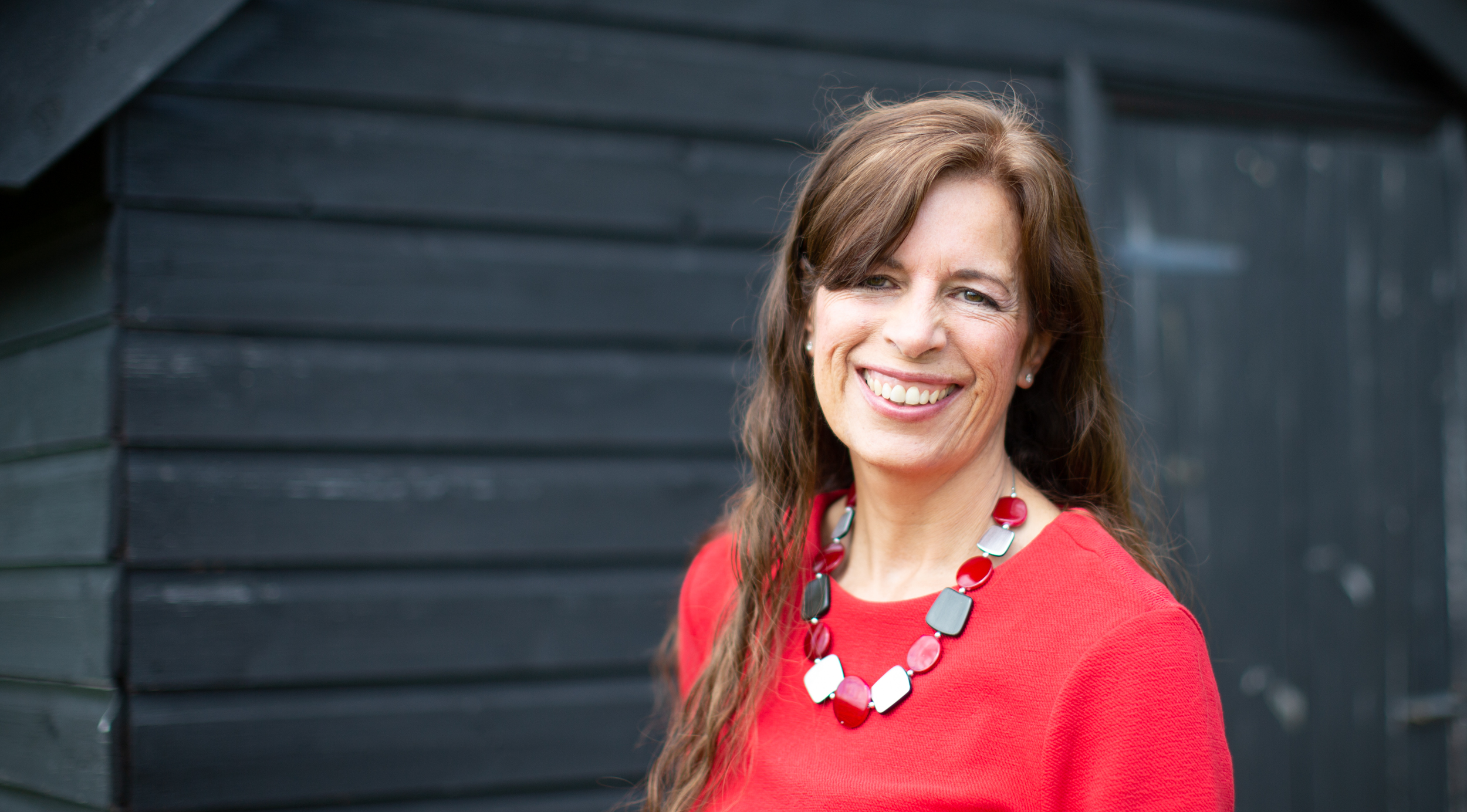 professional leaning on wooden wall